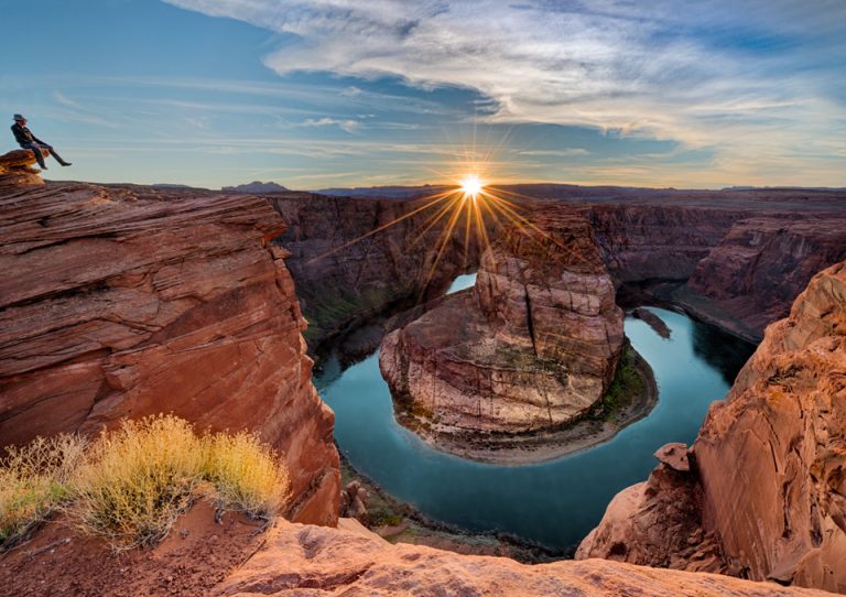 Sunset over Horseshoe Bend with winding Colorado River.